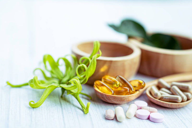 Dietary vitamin and mineral supplements in wooden bowls 